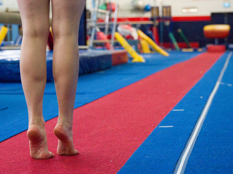 Gymnastics student standing at the end of the  long sprung track